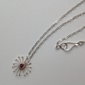 Silver Sunstar and Garnet Pendant