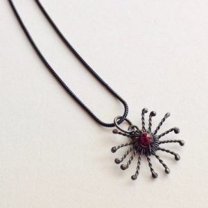 Silver Sunstar and Garnet Pendant