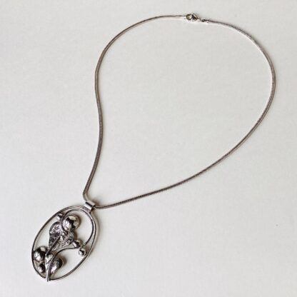 ‘Oval Silver Pendant with Leaves and Domes’