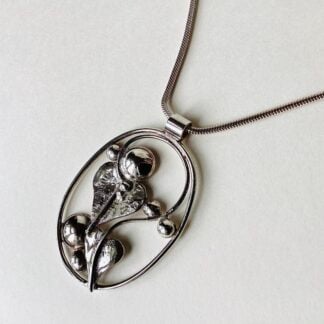 ‘Oval Silver Pendant with Leaves and Domes’