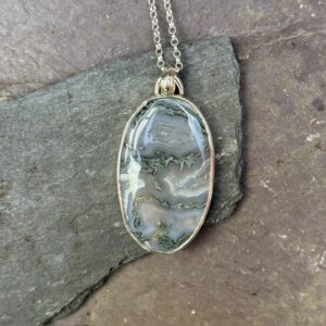 'Silver Otter over Moss Agate'